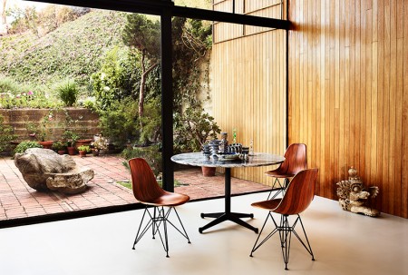 Charles Eames famously said,  "The role of the designer is that of a very good, thoughtful host anticipating the needs of his guests." With the molded, plastic, fiberglass, and wood shell chairs the Eames have created a universal response to what everyone wants from a chair: a simple, gracious form that fits any body and every place. This Eames Molded Wood Chair is available in 3 base options and walnut, ebony, white ash and Santos Palisander wood finishes.  