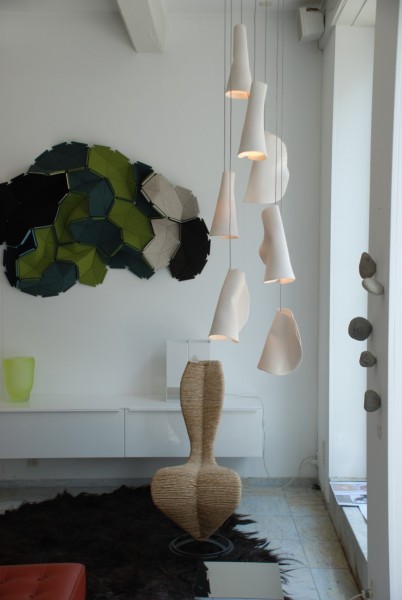 Inspired by the sporadic, perhaps discordant arrangement of barnacles on a rock surface, the 21 Series is fabricated from thin sheets of porcelain wrapped around frosted borosilicate glass trumpet-shaped diffusers.