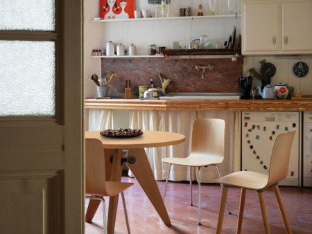 The Vitra Gueridon Table by Jean Prouvé, 1949, is an example of a round wood table that fits into smaller spaces. It is available in 2 sizes and pairs well with interesting chairs.