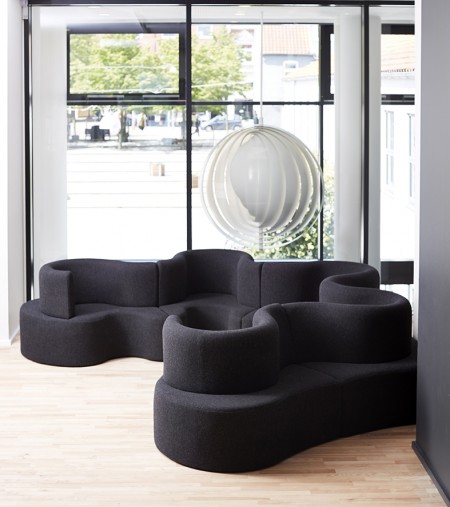 The Moon pendant is one of Verner Panton's earliest lamps, 1964. It consists of ten ring-shaped blades positioned in such a way that they can move. Here it is shown with Verner Panton's Cloverleaf Sofa.