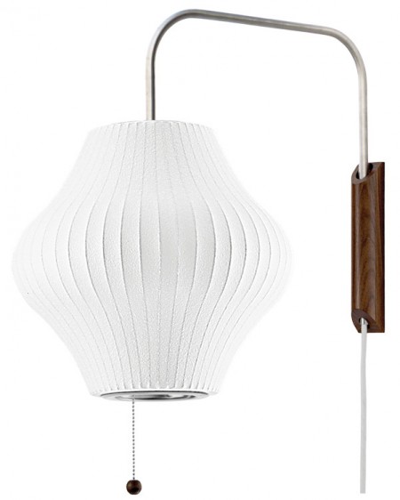 The George Nelson Bubble Lamp Pear Sconce is handsomely constructed with a 2-inch thick solid walnut wall-mount and a brushed-nickel steel arm that extends out approximately 14-inches. The arm has a swivel hinge and an adjustable 12-foot plug-in cord with a counterweight, that allows for height adjustments. This clever design allows one to adjust the sconce from left-to-right, and up-and-down, without having to change its position on the wall.