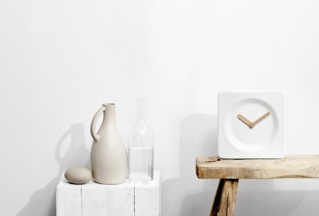 The LEFF amsterdam Tile Wall Clock, designed by Robert Bronwasser, 2013, can stand alone or hang on a wall. It has a white glazed ceramic body and bamboo hands.
