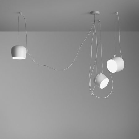 The AIM is a form of modern pendant lighting that is constructed from a varnished aluminum sheet with a photo-etched optical polycarbonate shade and an internal reflector of a photo-etched ABS. The cable can be adjusted to allow the fixture head and light distribution to be aimed. The cable has a total length of 29 ft 5 inches (9m) allowing the lamp to be suspended up to 9 ft 8inches (3m) from the ceiling.