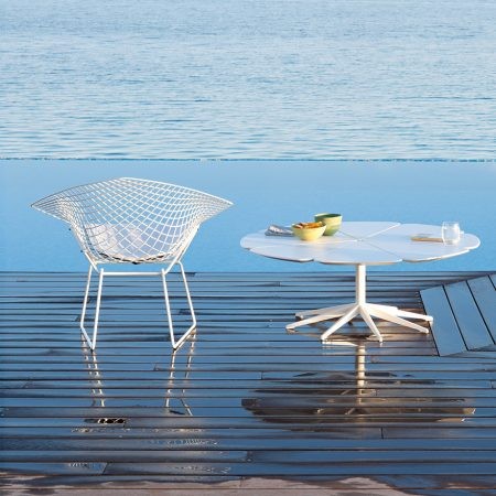The Knoll Petal Table was designed by Richard Schultz in 1960. He cites Queen Anne’s Lace as his inspiration for this delicate outdoor table with its flower-like top sprouting from the elegant pedestal base. Each  "petal" expands and contracts independently, ensuring stability in changing weather.